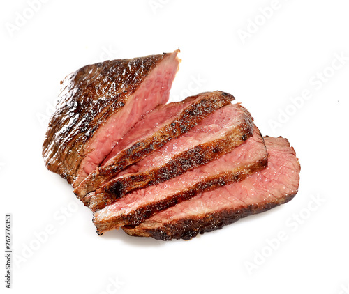 Grilled beef steak, sliced, isolated on white background.