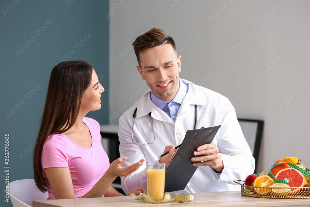 Young woman visiting nutritionist in weight loss clinic Young woman visiting nutritionist in weight loss clinic