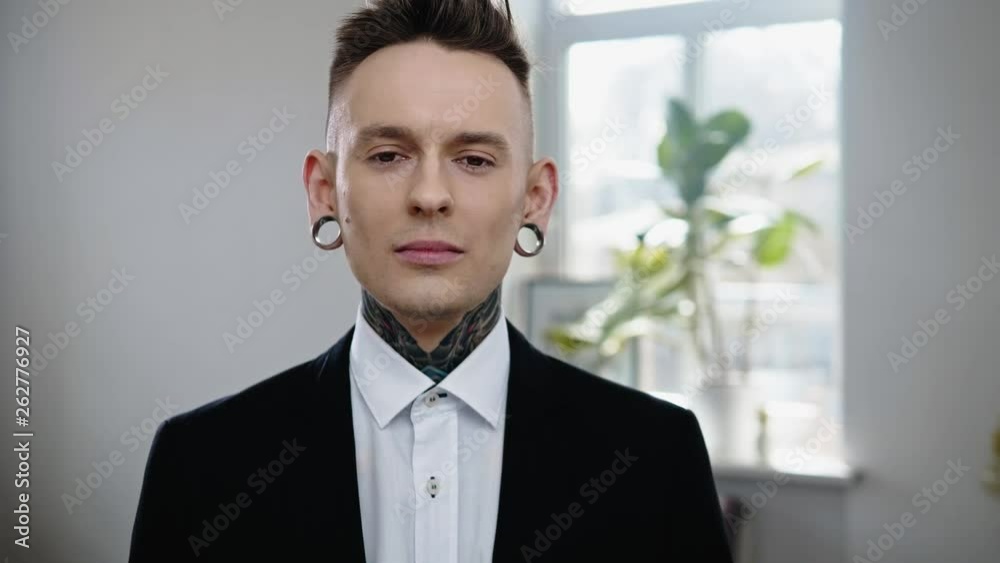 Portrait of alternative model with earplugs and tattoo Portrait of alternative model with earplugs and tattoo
