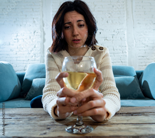 Portrait of sad, unhappy, helpless woman drinking wine. Human emotions, depression and alcoholism photo