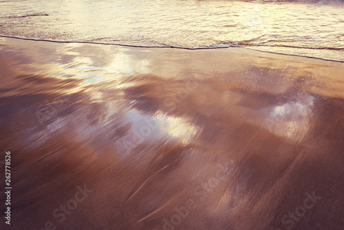 soft wave on the wet sand of the seashore photo