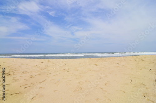 waves on the beach with beautiful white sand and blue sky background © Eksapedia