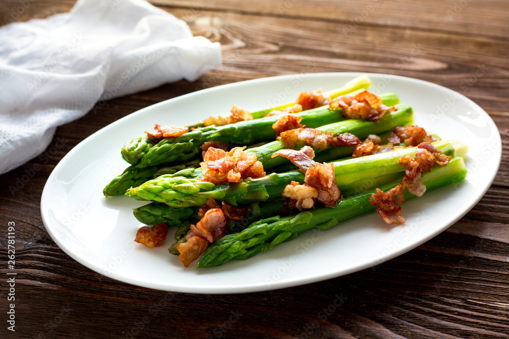 Baked asparagus with bacon. Wooden table. Paleo diet. Vegetarian. Homemade.