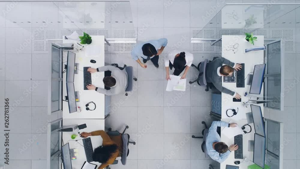 Aerial Top Down Drone Shot of Big Busy Corporate Office with Tow Rows off Businessmen and Businesswomen Working on Desktop Computers. Bright Open Space Office with Businesspeople and Salespeople