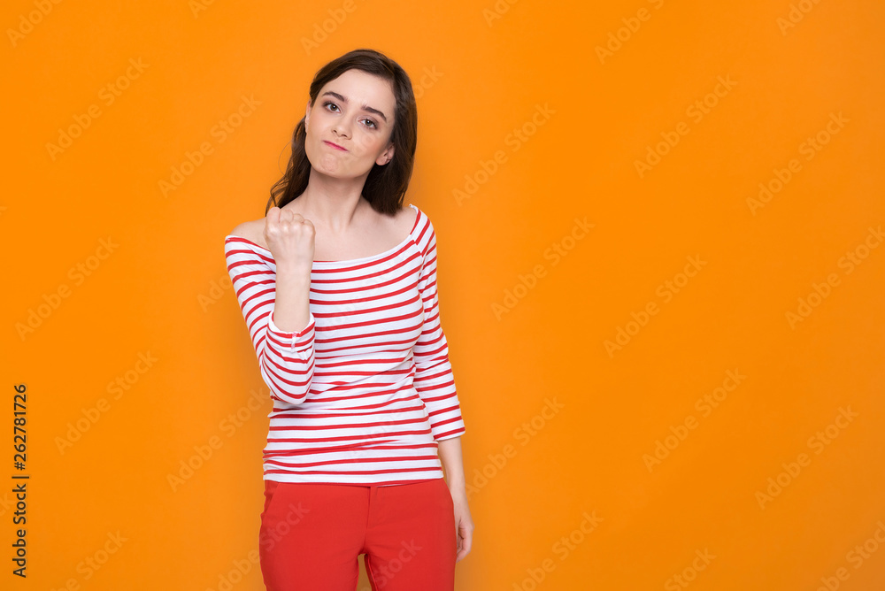 Waist up of angry brunette lady posing for camera in studio Waist up of angry brunette lady posing for camera in studio