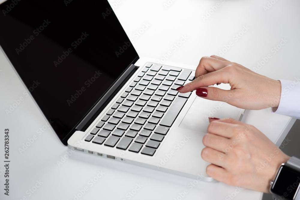 Woman's hand typing on computer keyboard Woman's hand typing on computer keyboard