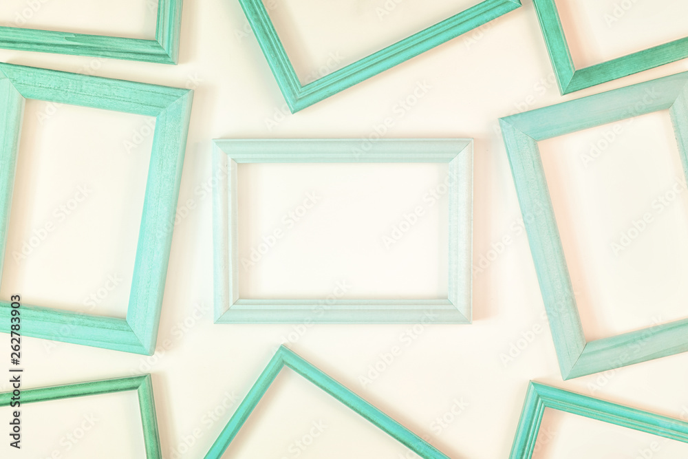 On a white background a lot of turquoise empty frames are laid out. Space for text, layout. Unusual concept. On a white background a lot of turquoise empty frames are laid out. Space for text, layout. Unusual concept.