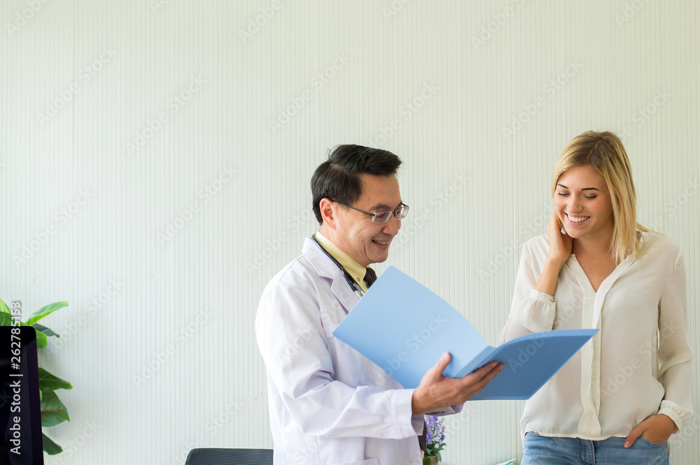 Senior doctor examining result to woman patient and follow up treatment at hospital Senior doctor examining result to woman patient and follow up treatment at hospital