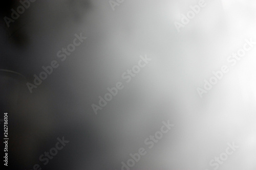 Stream of thick smoke on a dark background, abstraction.