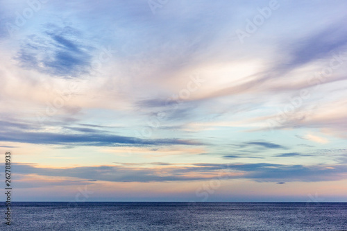 Painterly seascape scene with relaxing sunset colours falling over the ocean. © timallenphoto