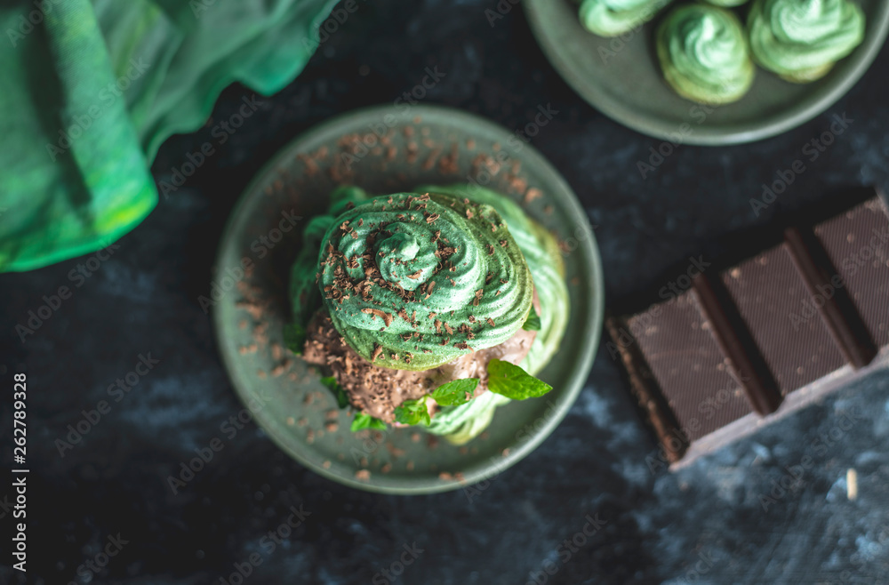 mint meringue with chocolate cream on a dark, moody background mint meringue with chocolate cream on a dark, moody background