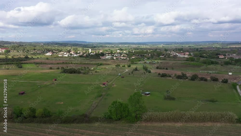 Peaceful rural area in France vineyards and crop fields cloudy day aerial drone shot Peaceful rural area in France vineyards and crop fields cloudy day aerial drone shot