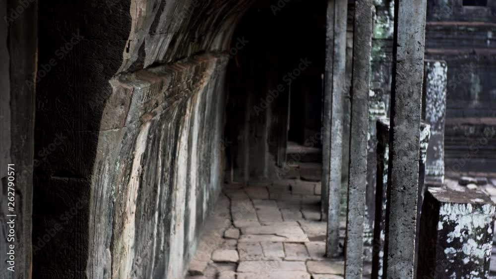 Sliding view of long empty inner corridor in the Bayon temple. Built in 12-13th century it stands at the centre of Jayavarman's capital, Angkor Thom. Cambodia Sliding view of long empty inner corridor in the Bayon temple. Built in 12-13th century it stands at the centre of Jayavarman's capital, Angkor Thom. Cambodia