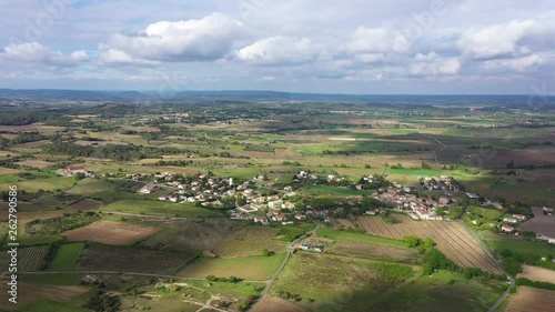 Beautiful rural aerial drone shot over Campagne village vineyards and crop fields around sunset with clouds 