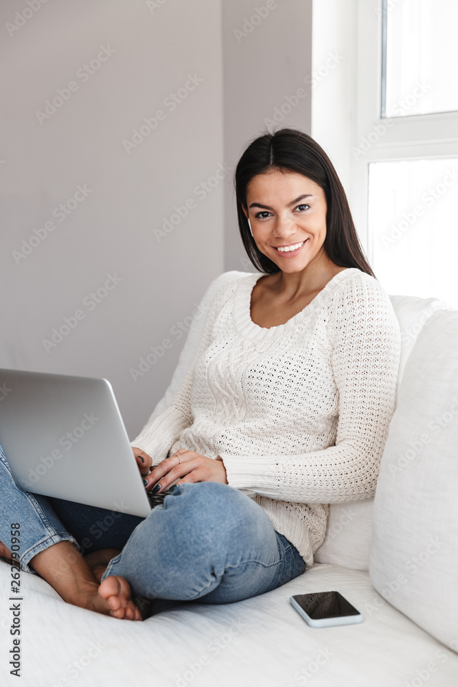 Pretty young woman relaxing on a couch at home Pretty young woman relaxing on a couch at home