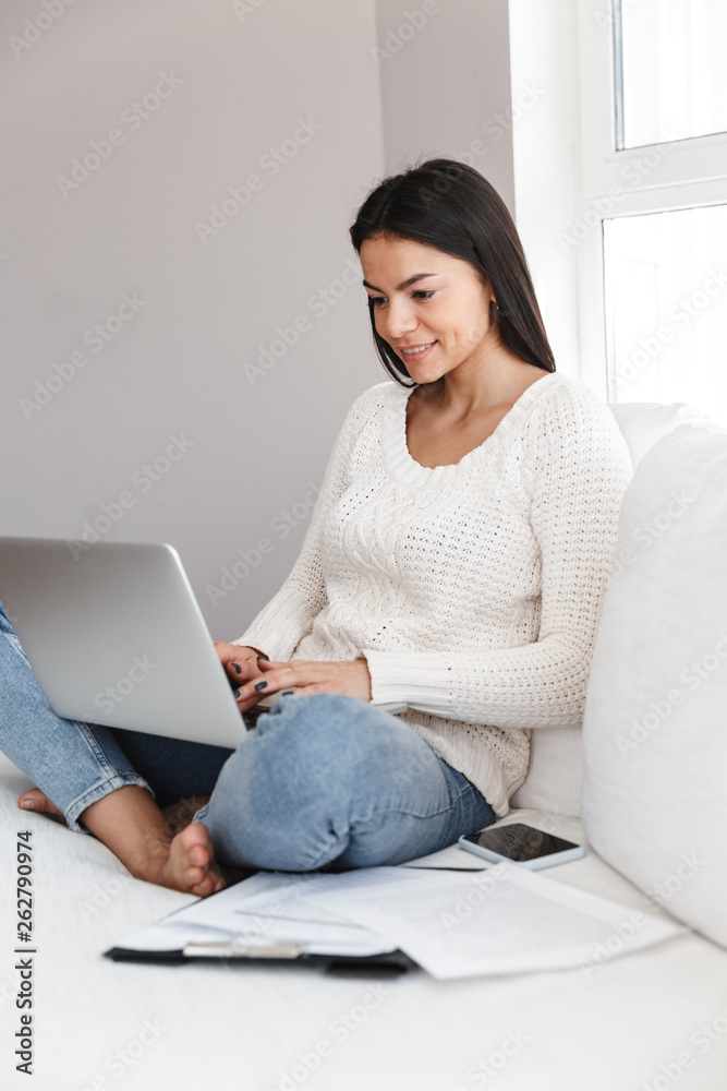 Pretty young woman relaxing on a couch at home Pretty young woman relaxing on a couch at home