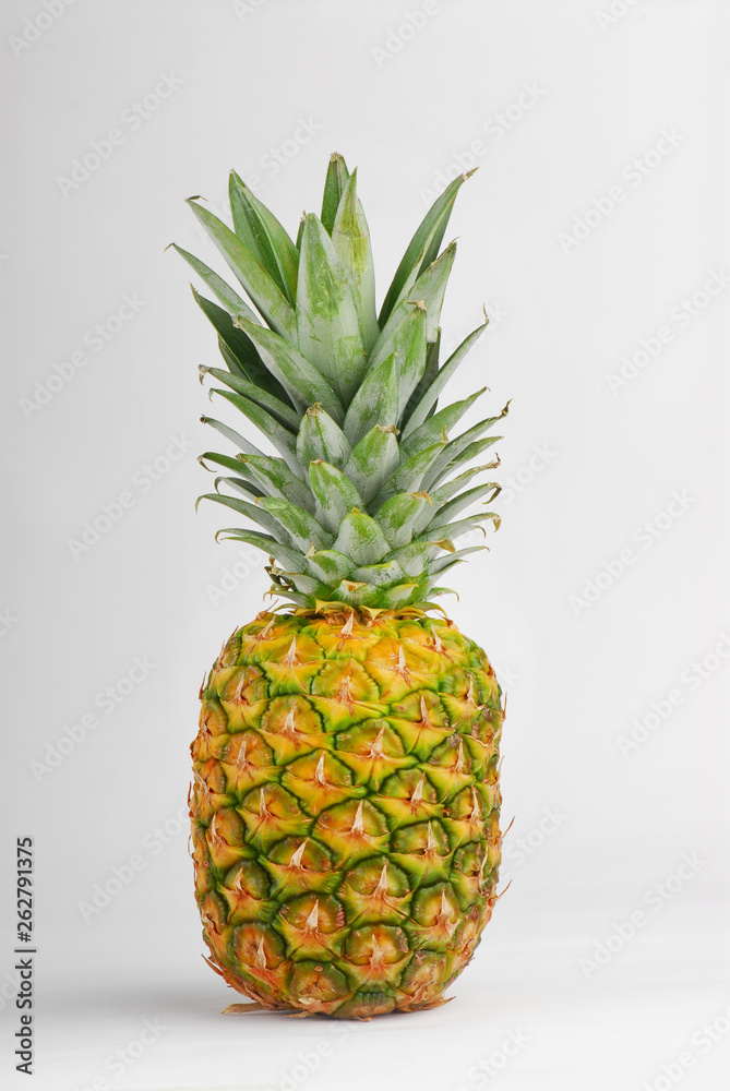 Fresh pineapple on an isolated gray background
