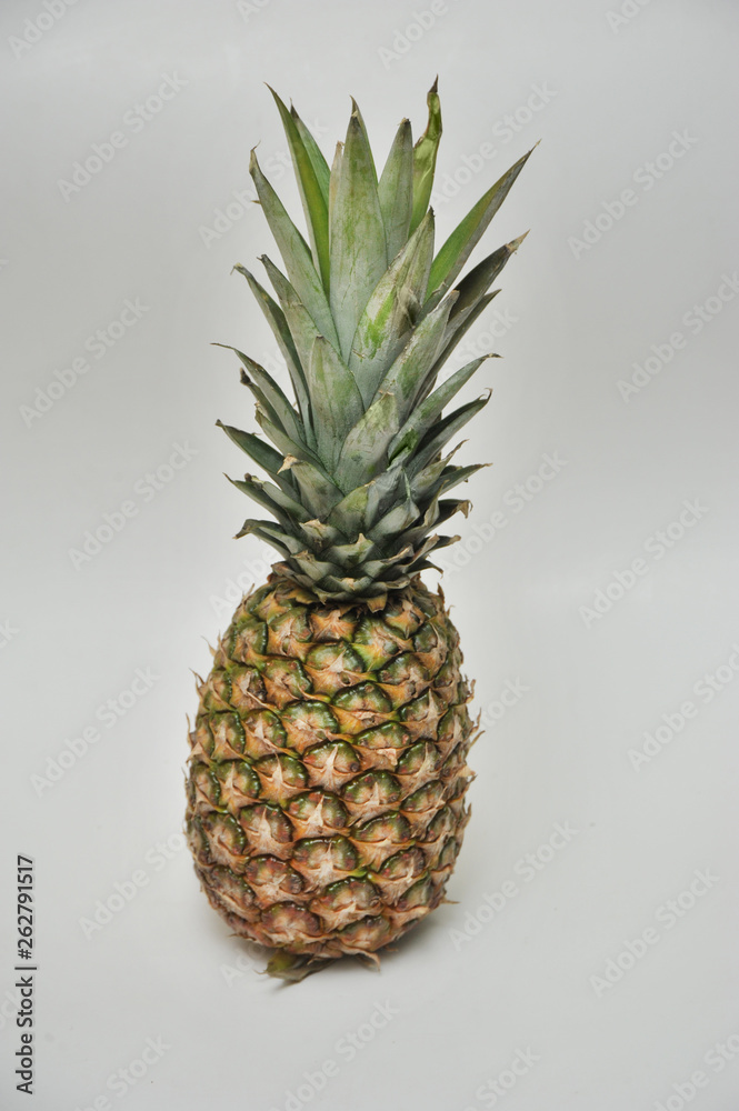 Fresh pineapple on an isolated gray background Fresh pineapple on an isolated gray background