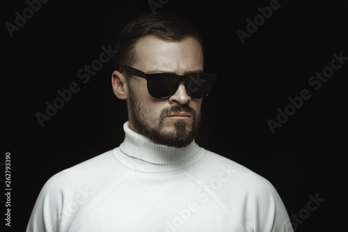 Portrait of Man in White Against Black Indoors