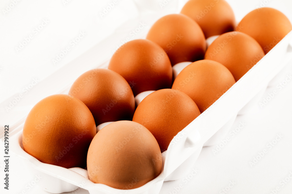 brown eggs in plastic package on white background. brown eggs in plastic package on white background.