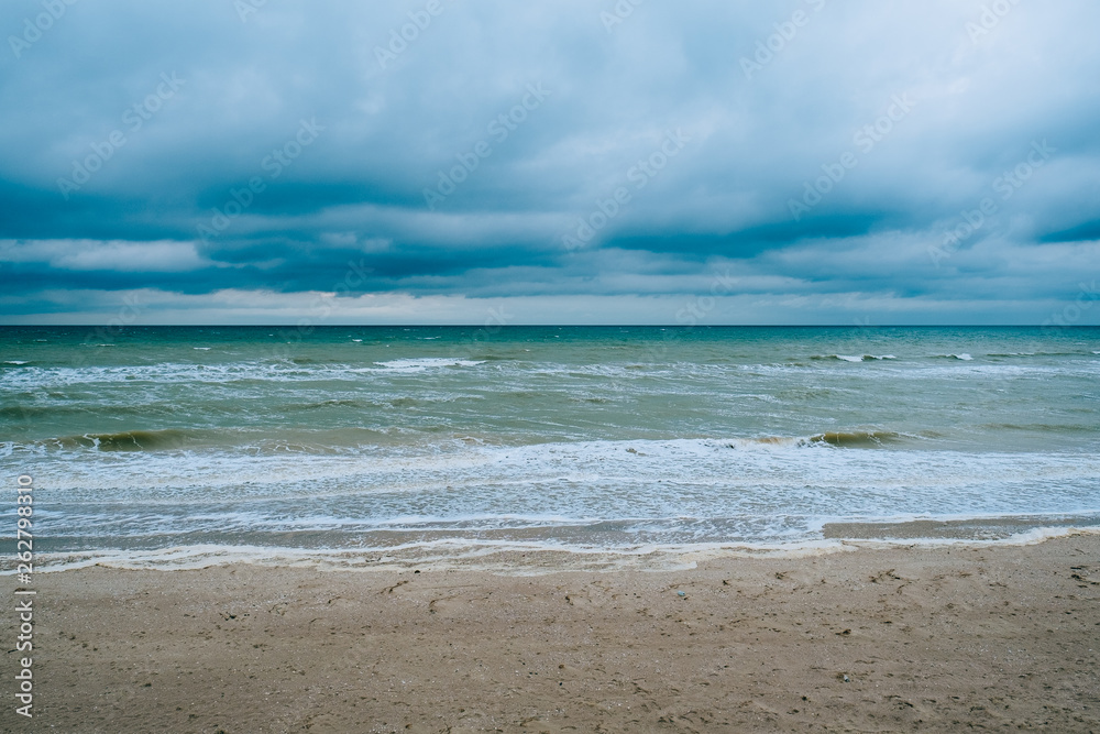 Windy storm beach seashore seaside sea waves dark clouds