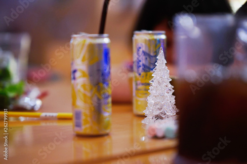 Glass christmas tree in the middle around by party can and beverages