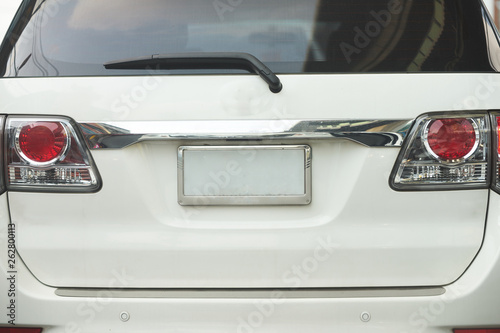 Rear aspect or back view of SUV car and plate  in day time on road