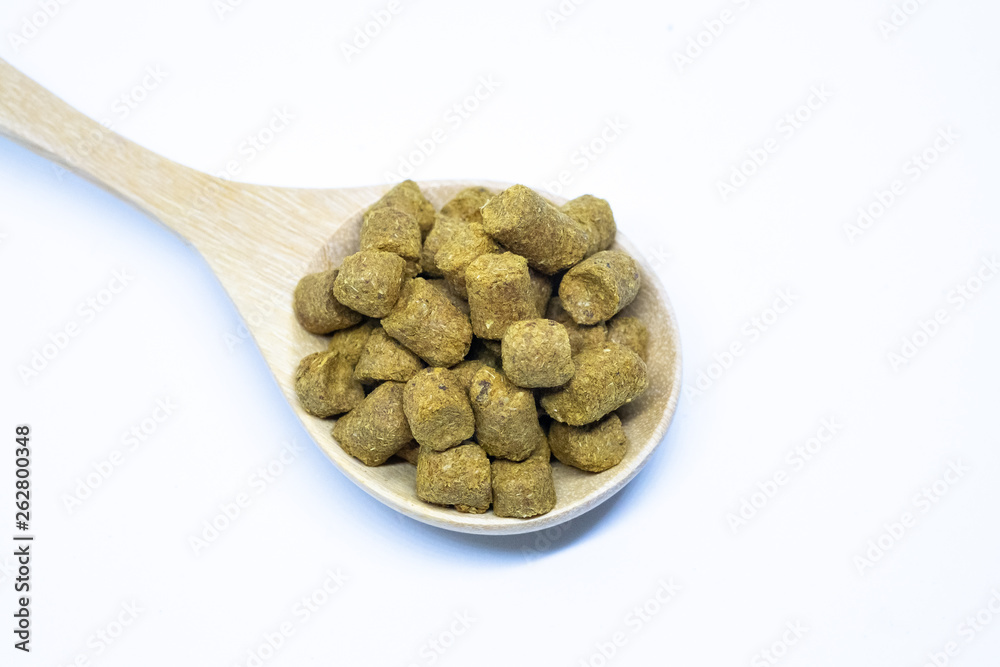 Pellets hops on a spoon wood for home brewing Isolate.