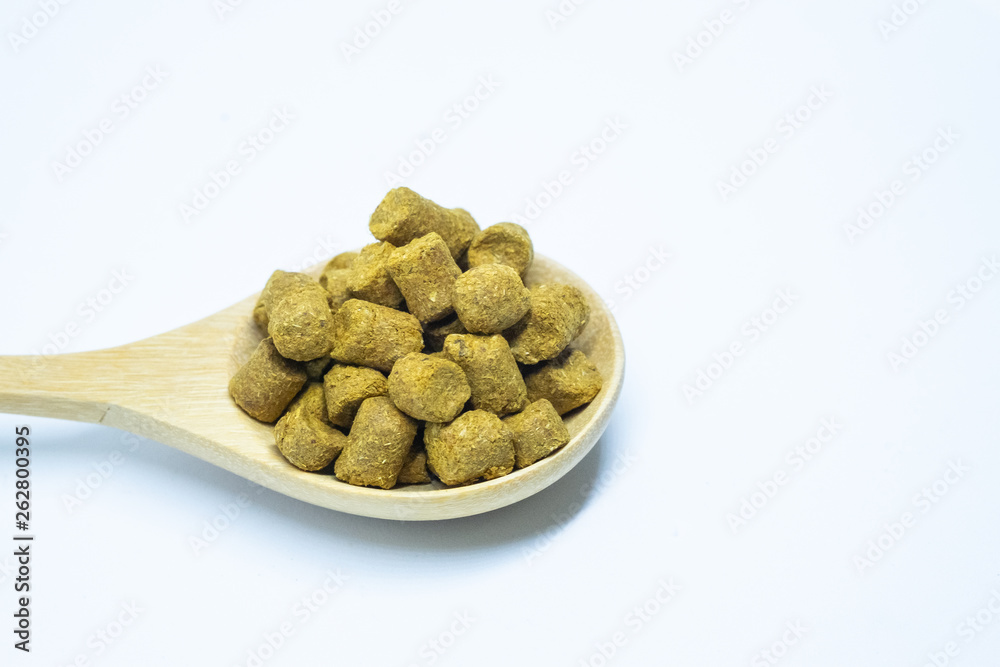 Pellets hops on a spoon wood for home brewing Isolate. Pellets hops on a spoon wood for home brewing Isolate.