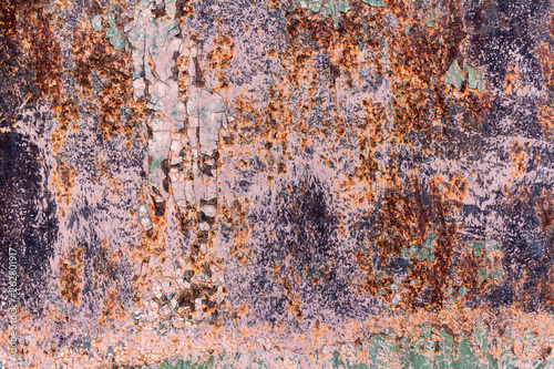 Old cracked rusty damaged painted metal background texture close-up