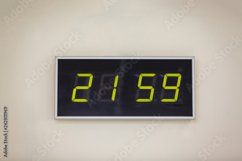 Black digital clock on a white background showing time 21.59 minutes