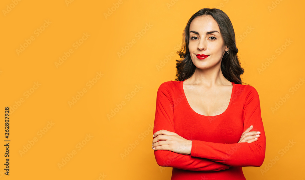 Ladyship. Spicy-orange background with pretty girl in deep red sweater, with matching lip color and crossed hands over her breast. Ladyship. Spicy-orange background with pretty girl in deep red sweater, with matching lip color and crossed hands over her breast.
