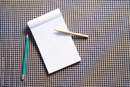 Notebook and pencils on the table