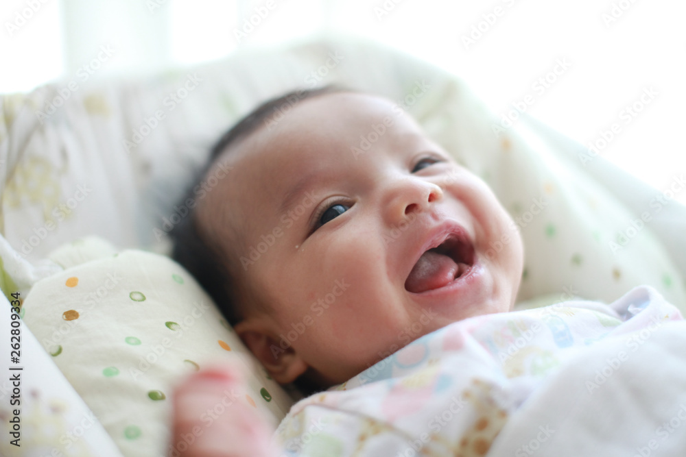 Baby girl is smiling and laugh on her cradle Baby girl is smiling and laugh on her cradle