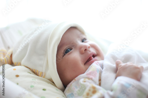 Baby girl is smiling and laugh on her cradle