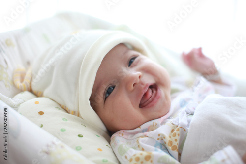 Baby girl is smiling and laugh on her cradle