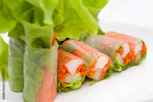 Salad roll on a wood dish in white background