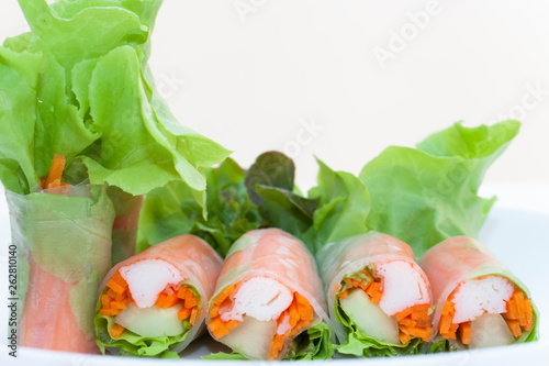 Salad roll on a wood dish in white background