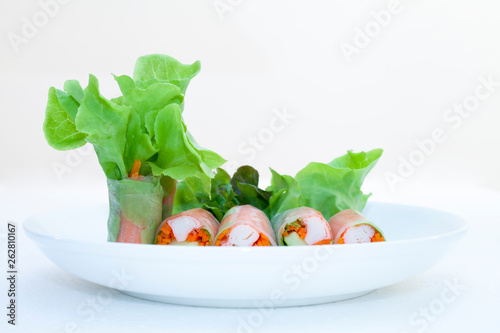 Salad roll on a wood dish in white background