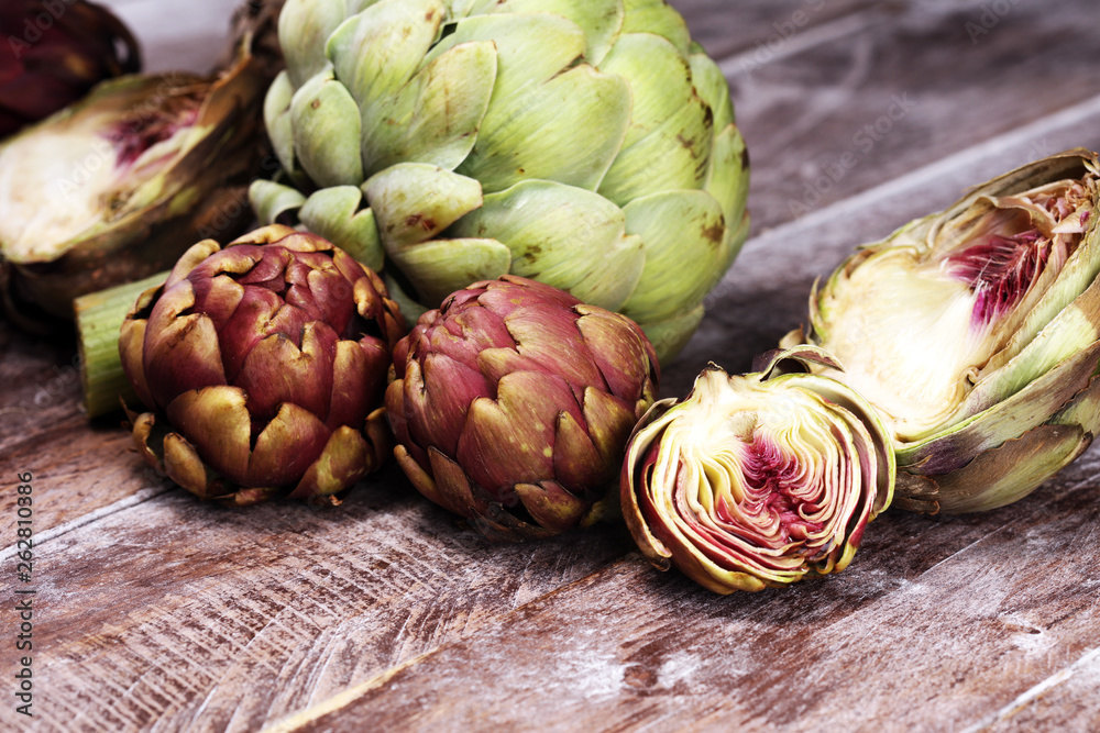 Fototapeta premium artichokes on grey background. fresh organic artichoke flower vegetable