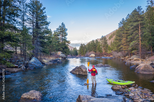 male paddler with an inflatable whitewater kayak
