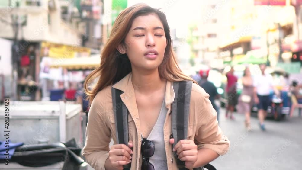 Young Asian female tourist woman with smile walking and backpacking on Khaosan road in Bangkok, Thailand. Travel and Backpack in Asia concept Young Asian female tourist woman with smile walking and backpacking on Khaosan road in Bangkok, Thailand. Travel and Backpack in Asia concept