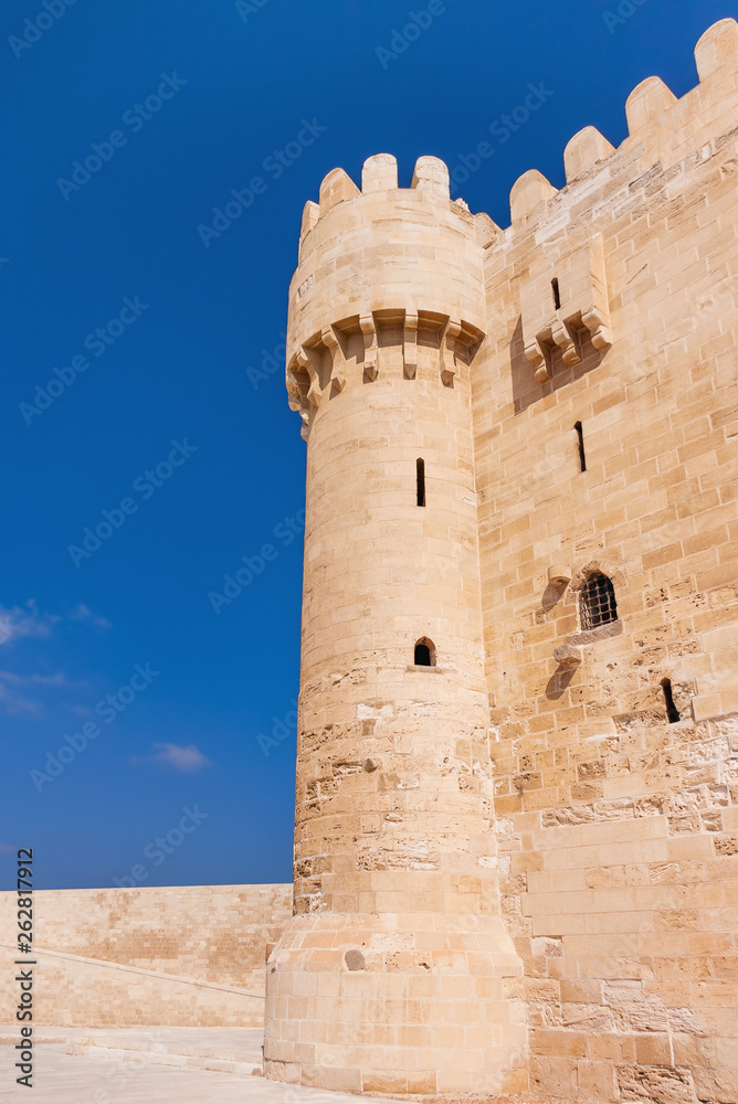 Tower and wall of citadel of Qaitbay fortress. Antique landmark in Alexandria, Egypt.