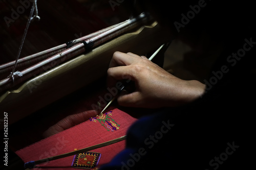 Hand weaving pattern on silk fabric cloth. Folk wosdom cultural of Thai style.