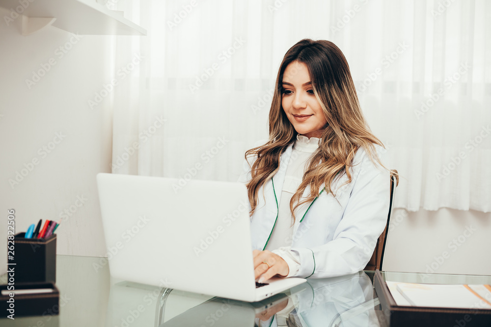 Young female doctor working in hospital office. Medical and healthcare concept. Young female doctor working in hospital office. Medical and healthcare concept.