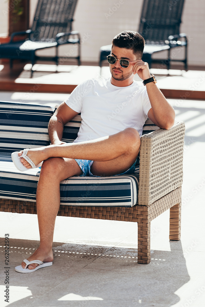 Man in sunglasses sitting outside on sunny day Man in sunglasses sitting outside on sunny day