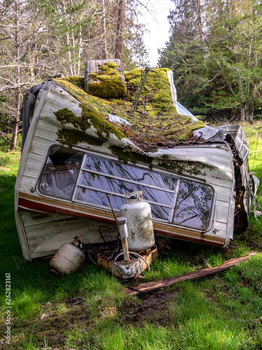 Trashed Trailer. An abandoned trashed trailer on a rural lot.