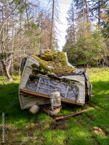 Trashed Trailer. An abandoned trashed trailer on a rural lot.
