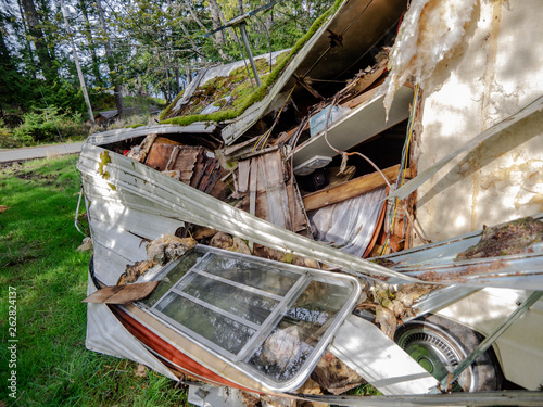 Trashed Trailer. An abandoned trashed trailer on a rural lot. photo