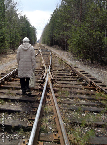 woman walking on railroad